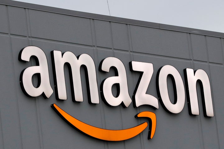 A sign is lit on the facade of an Amazon fulfillment center on Staten Island in New York. The company plans to hire another 100,000 new workers in their fulfillment centers to fill increased customer demand during the coronavirus outbreak in which many Americans are working from home and discouraged from going out.