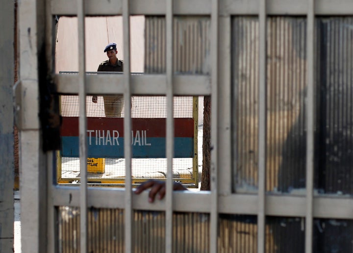 A policeman walks inside the Tihar Jail in New Delhi March 11, 2013.