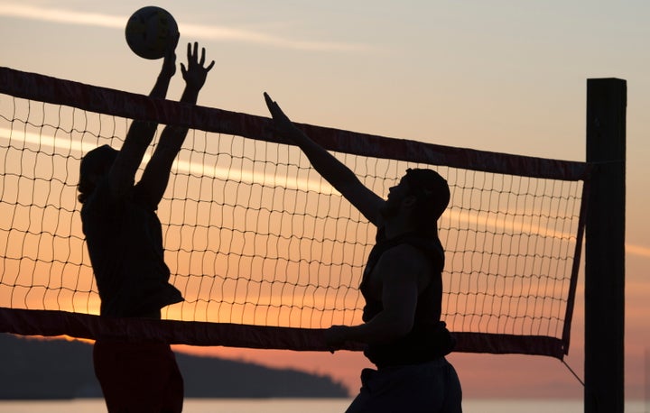 People play volleyball on Kitsilano Beach in Vancouver, British Columbia, in spite of the province urging people to practice social distancing.