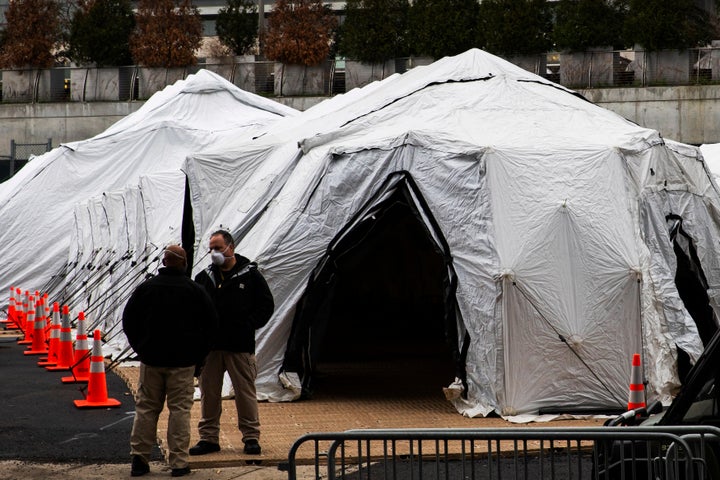 NEW YORK, NY - MARCH 25: People speak near a makeshift morgue outside of Bellevue Hospital on March 25, 2020 in New York City, New York. Across the country schools, businesses and places of work have either been shut down or are restricting hours of operation as health officials try to slow the spread of COVID-19. (Photo by Eduardo Munoz Alvarez/Getty Images)