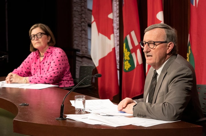 Toronto Medical Officer of Health Dr. Barbara Yaffe (left) listens as Ontario Chief Medical Officer of Health Dr. David Williams speaks at Queen's Park in Toronto on March 25, 2020.