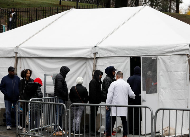 People queue up to to test for the coronavirus disease at a field clinic at the Brooklyn Hospital Center in New York City.