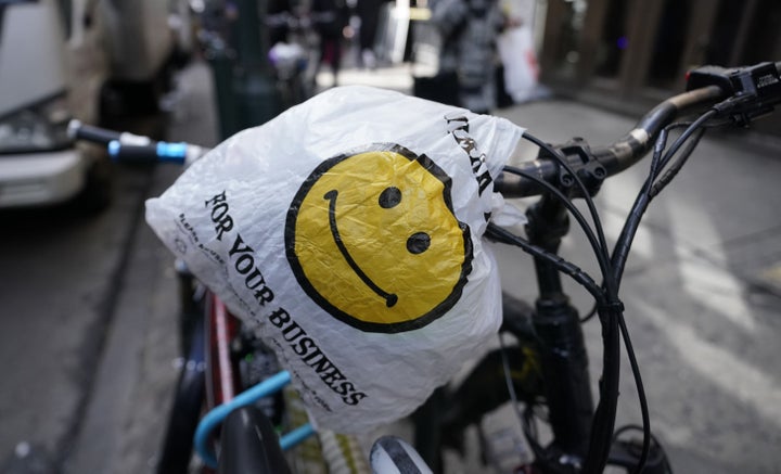 A food delivery man with food in plastic bags on the Upper East Side in New York on February 28, ahead of the statewide ban on plastic bags that took effect March 1.