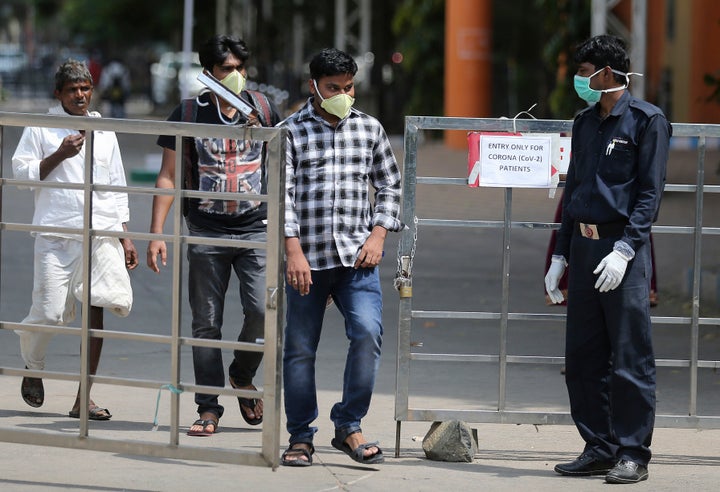 People walk through a gate at government run Gandhi Hospital in Hyderabad, March 6, 2020.