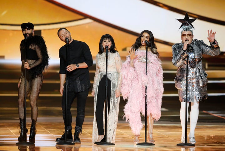 Former participants in the Eurovision Song Contest, Austria's Conchita Wurst, Swedish Mans Zelmerlow, Israeli singer Gali Atari, Greek singer Eleni Foureira and Ukrainian singer Verka Serdyuchka, from left, perform during the 2019 Eurovision Song Contest grand final in Tel Aviv, Israel, Saturday, May 18, 2019. (AP Photo/Sebastian Scheiner)