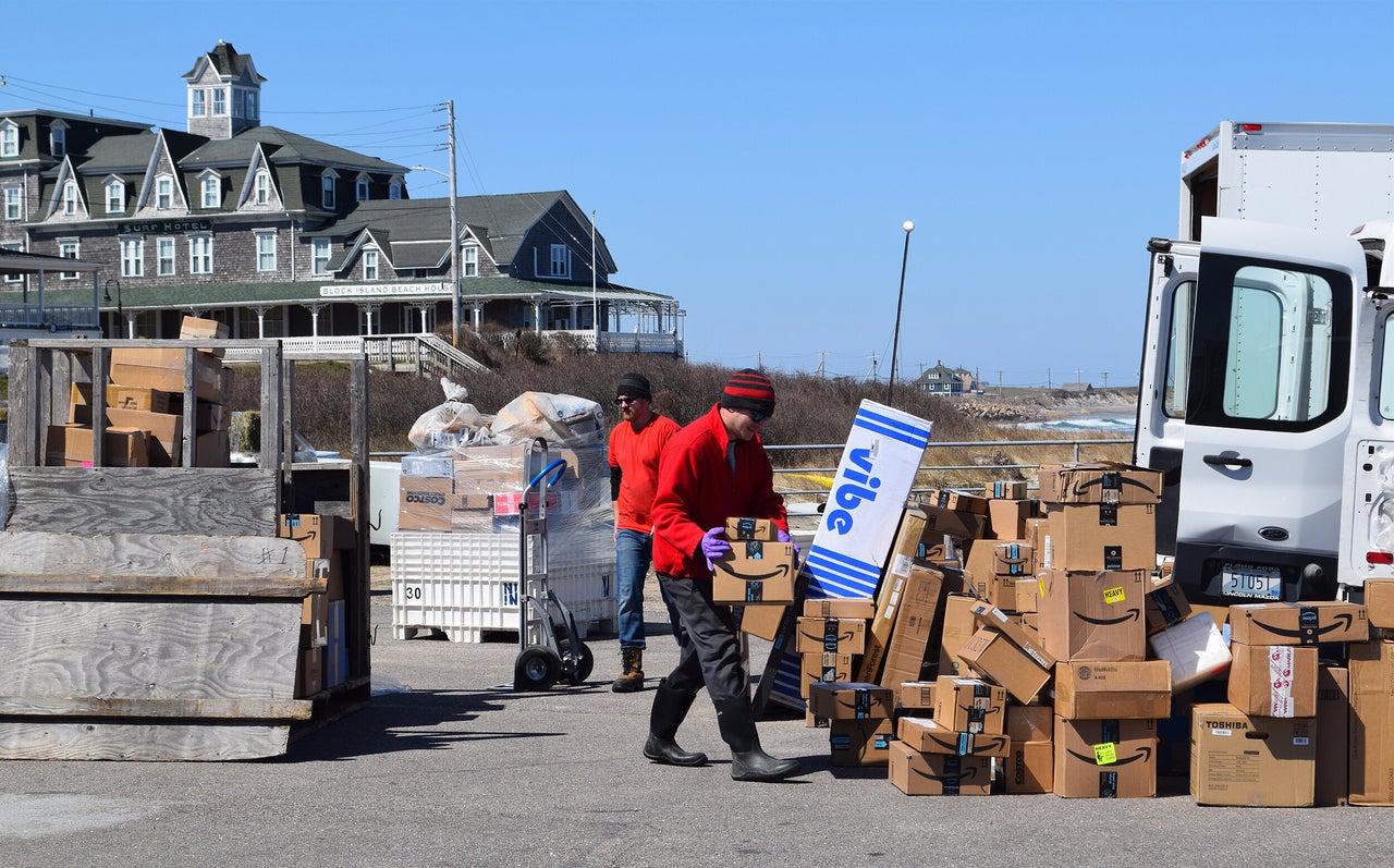 A package delivery service on the island loads deliveries from companies like Amazon on March 26.