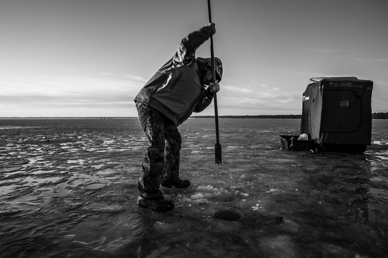 Trey Pipesh punches a hole in the ice on Tawas Bay on Lake Huron on Dec. 22, 2019. An auger is normally required to drill through thick ice, but on this day the ice is thin enough to pierce through with a spud -- a long piece of steel that is tapered at the end and usually used to test or measure the thickness of the ice.