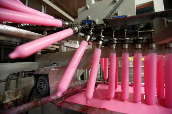 Moulds are dipped into latex to make condoms at the Karex condom factory in Pontian, Malaysia, Nov. 7, 2012. Malaysia's Karex Industries is the world's largest condom maker by volume, and it has shut down operations due to COVID-19.