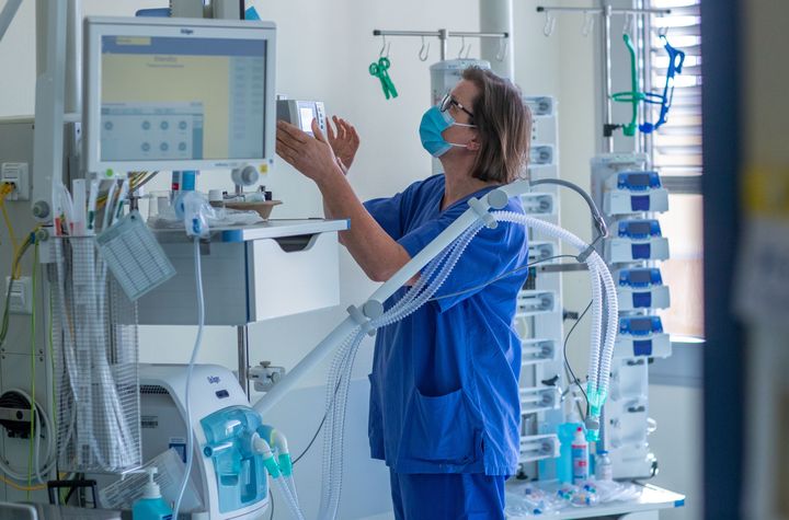 A nurse checking a ventilator in a room of the intensive care unit in Germany