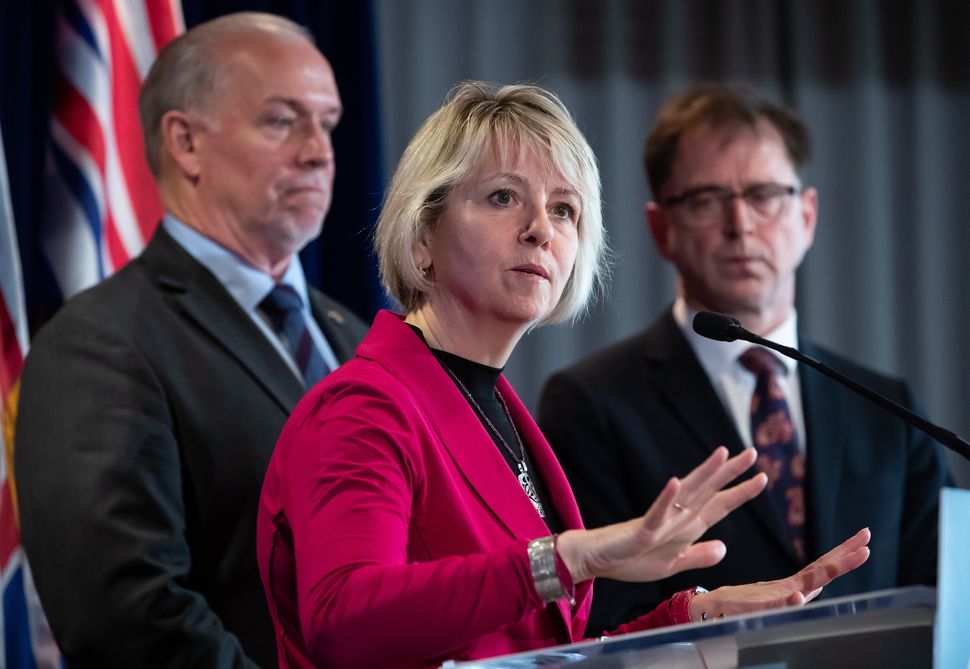 Provincial health officer Dr. Bonnie Henry responds to questions while B.C. Premier John Horgan and Health Minister Adrian Dix listen behind during a news conference in Vancouver on March 6, 2020. 