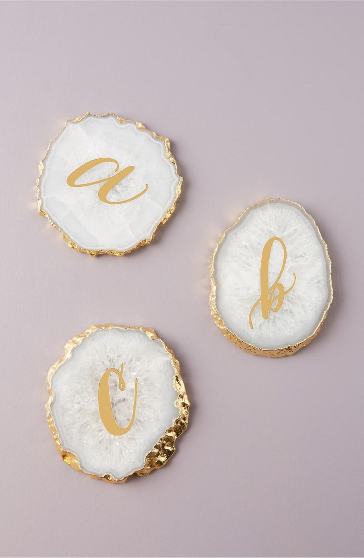 A shining monogram adds personalized polish to a coaster handcrafted in lustrous sliced agate.