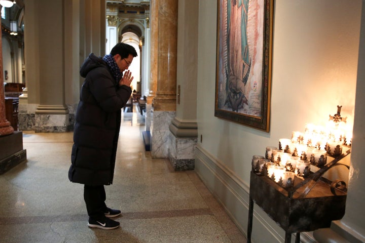 Jun Lee, a Catholic from South Korea, prays during a visit to St. James Cathedral in Seattle, which is open only for prayer a