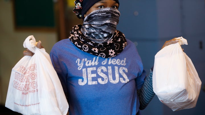 Volunteer Delores Wyatt prepares bags of food for distribution at the Brightmoor Connection Food Pantry in Detroit on Monday.