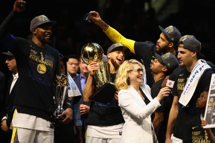 NBA analyst Doris Burke pictured alongside the Golden State Warriors after the team defeated the Cleveland Cavaliers in the 2018 NBA Finals.