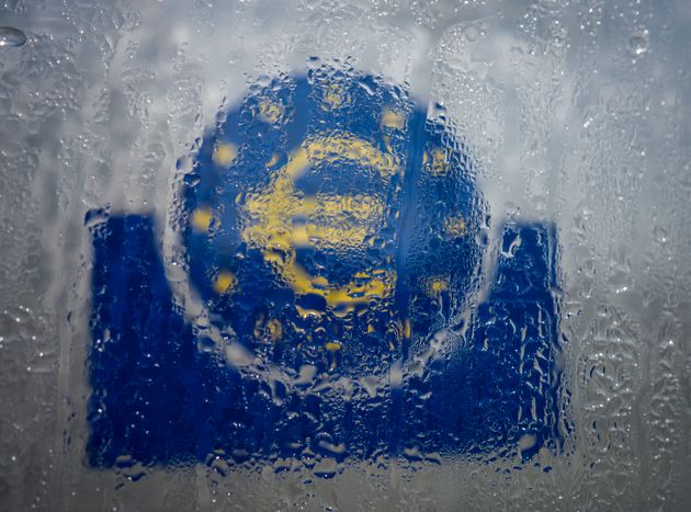 19 March 2020, Hessen, Frankfurt/Main: Water has settled in the glass welcome sign with a euro symbol at the southern entrance to the headquarters of the European Central Bank (ECB). In the fight against the consequences of the coronavirus crisis, the European Central Bank (ECB) has made 115 billion euros available to the banks in the euro zone in a long-term refinancing transaction. Photo: Frank Rumpenhorst/dpa (Photo by Frank Rumpenhorst/picture alliance via Getty Images)