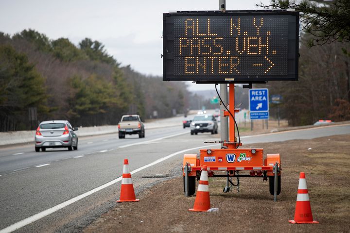A sign tells motorists with New York license plates to pull over at a checkpoint on I-95 in Rhode Island.