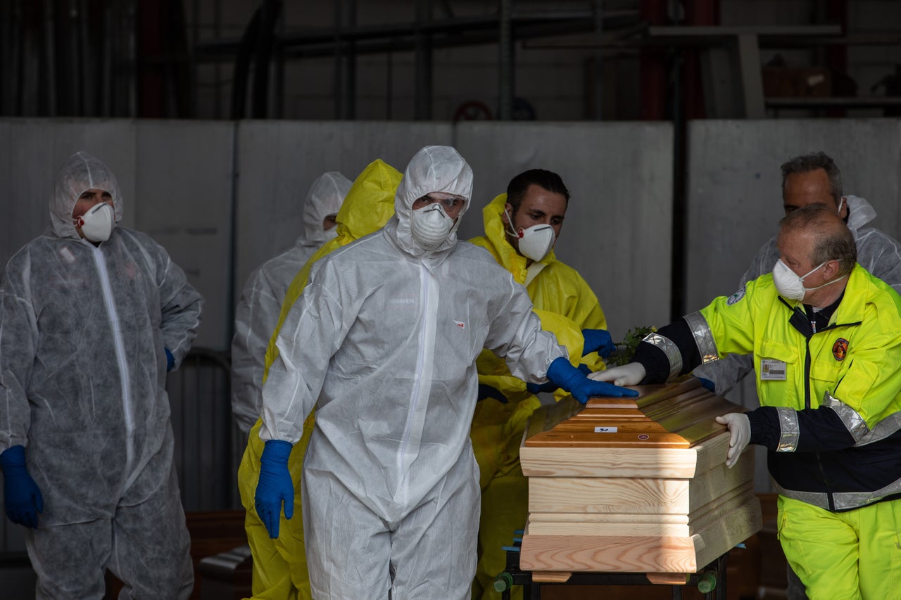 Carabinieri officers, wearing protective suits, transport coffins in Ponte San Pietro, near Bergamo, Northern Italy. The country has seen a higher number of deaths from the virus than anywhere else in the world. 