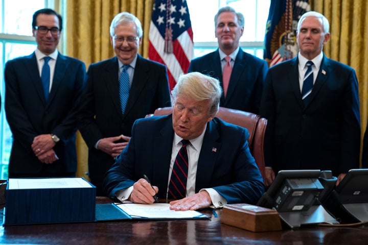 President Donald Trump signed the $2 trillion coronavirus stimulus relief package in the Oval Office at the White House on Friday.