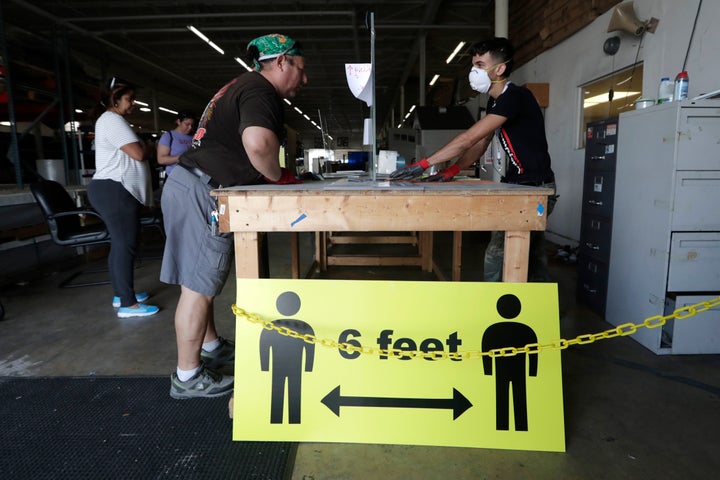 A sign advises social distancing of 6 feet to protect against the coronavirus in Hialeah, Florida.