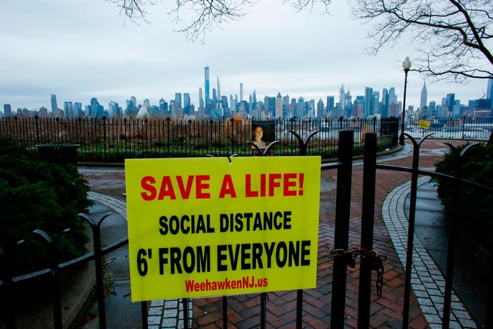 A sign encouraging social distancing to stop the spread of coronavirus is displayed at a closed park in Weehawken, New Jersey, on Saturday.
