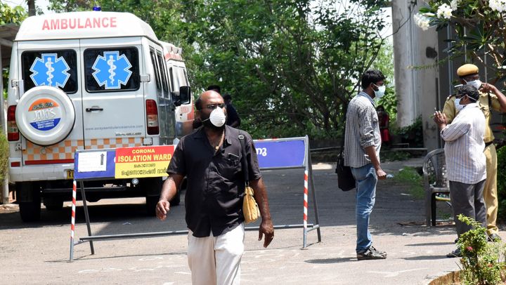 People seen wearing masks outside the special isolation ward set up to provide treatment to novel coronavirus patients at Kochi Medical college, in Kerala, March 9, 2020. 