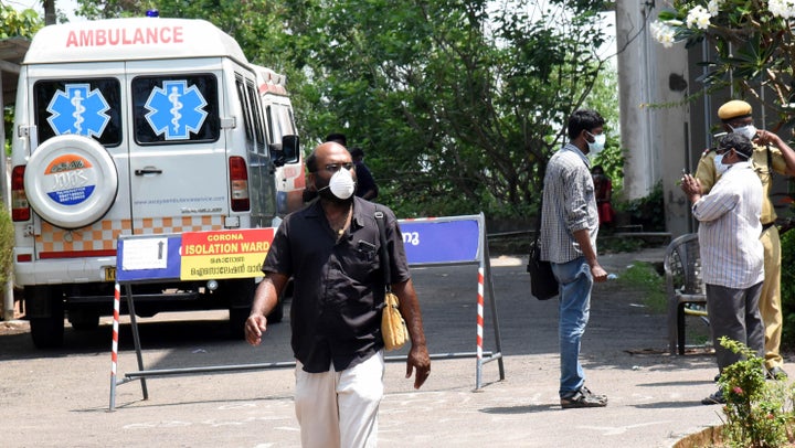 People seen wearing masks outside the special isolation ward set up to provide treatment to novel coronavirus patients at Kochi Medical college, in Kerala, March 9, 2020.
