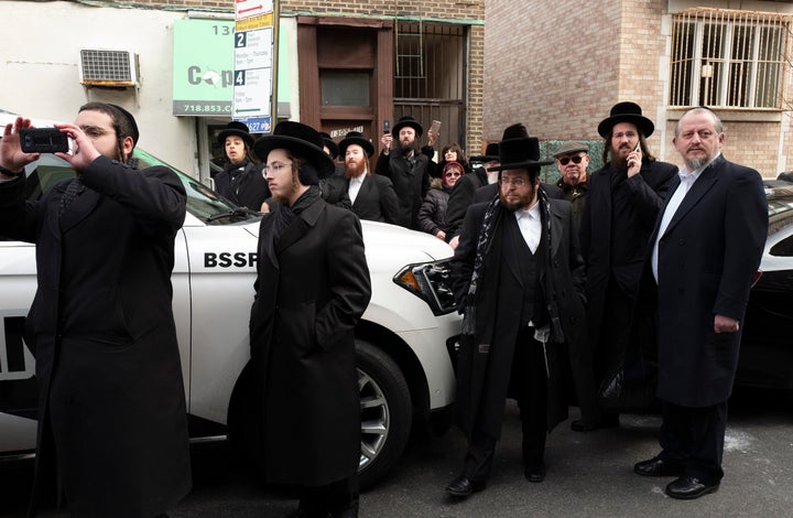 Members of the Borough Park community watch for U.S. Attorney William Barr as he leaves a meeting with Jewish leaders at the Boro Park Jewish Community Council, on Jan. 28 in New York. Jewish communities in the New York City metro area have been on edge after a shooting rampage at a northern New Jersey market in December and an attack at a Hanukah celebration in Monsey, N.Y. that left five people wounded.