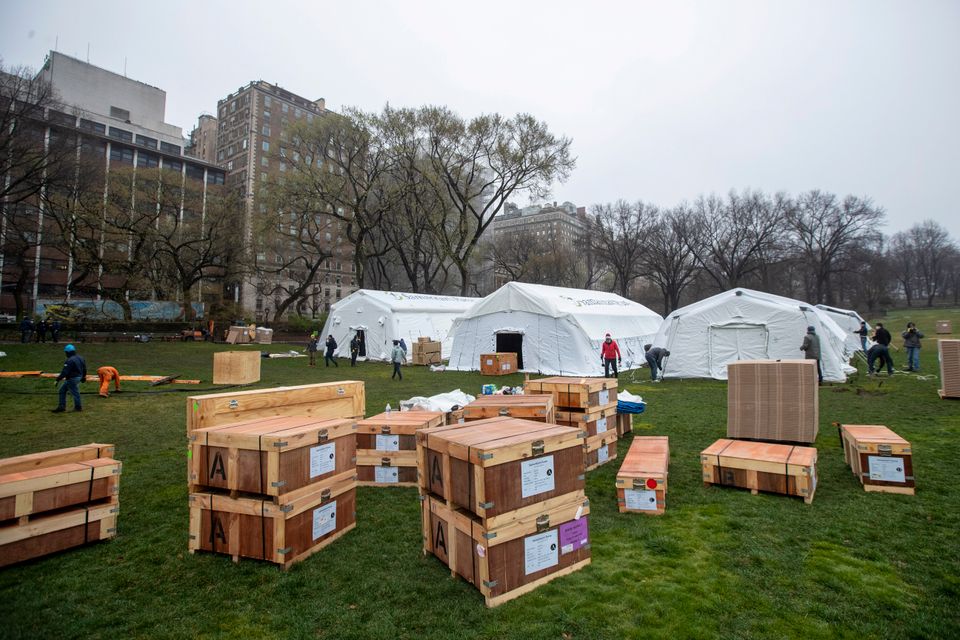 A Samaritan's Purse crew works on building an emergency field hospital equipped with a respiratory unit in New York's Central Park across from the Mount Sinai Hospital on Sunday.