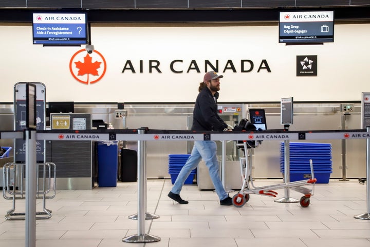 An Air Canada check-in desk at the airport in Calgary, Alta., Wed. March 25, 2020, amid a worldwide COVID-19 flu pandemic.