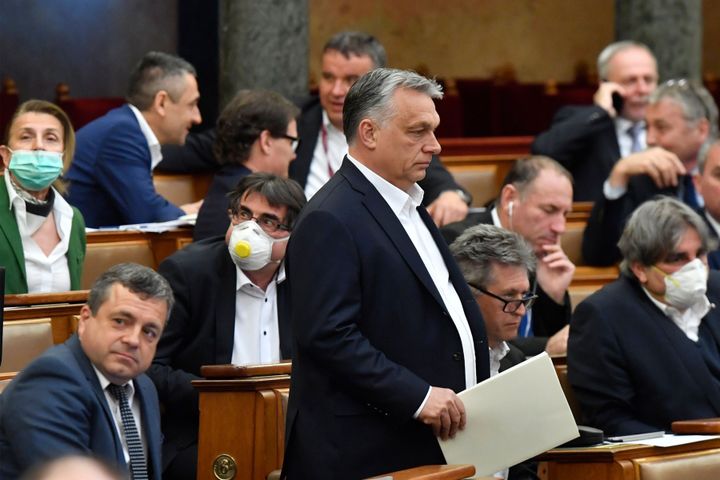 Hungarian Prime Minister Viktor Orban (standing) at the session of the Hungarian Parliament in Budapest on Monday where his government gained sweeping powers amid the coronavirus crisis. Critics express deep concerns about how he will wield his new authority.