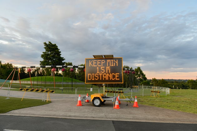 An information signboard 'Keep min 15m distance' is seen at outdoor playground at Sydney Olympic Park area on March 30, 2020 in Sydney, Australia. (Photo by Izhar Khan/NurPhoto via Getty Images)