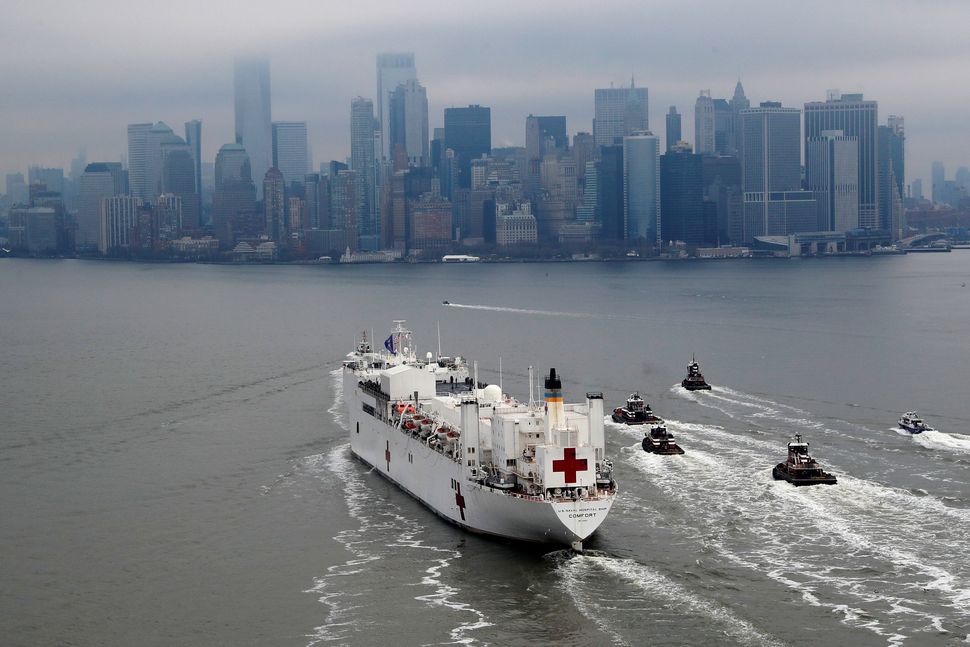 The USNS Comfort passes Manhattan as it enters New York Harbour.