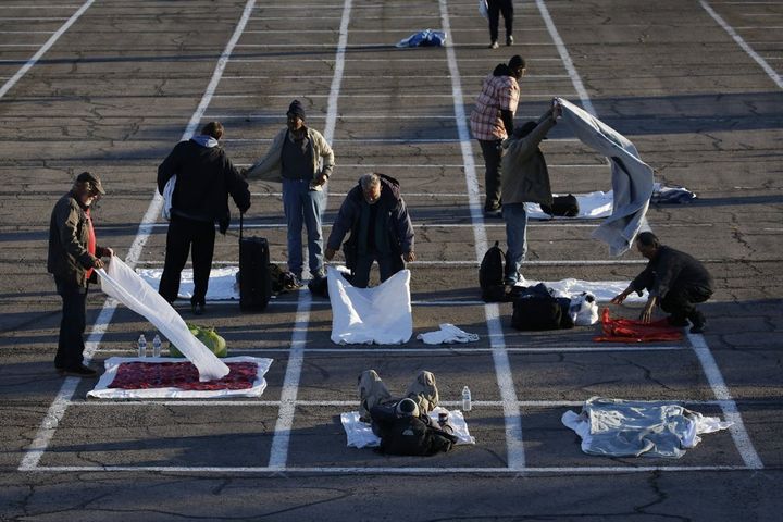 Homeless people in Las Vegas have been directed to sleep in rectangles painted on the pavement in a makeshift parking lot camp as a way to limit the spread of the coronavirus.