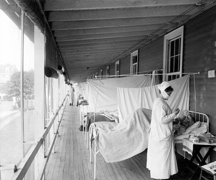 A nurse checking on a patient at the Walter Reed Hospital Flu Ward in Washington during the influenza pandemic of 1918.