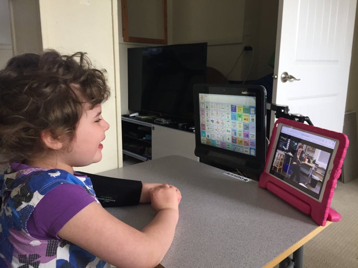 Duane Froese's daughter participates in a session with her educational assistant.