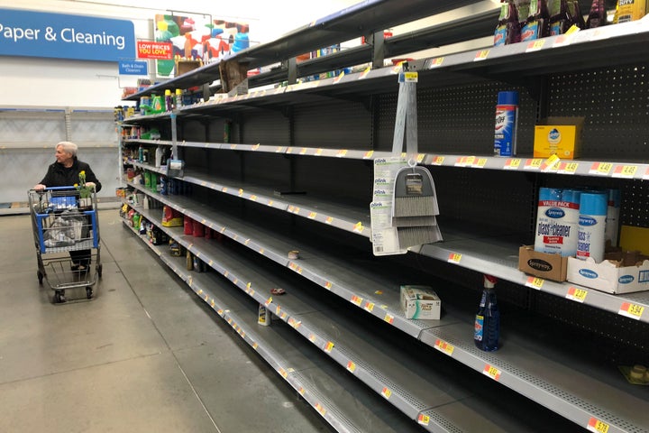 Shelves are nearly empty at a Walmart in Warrington, Pennsylvania, on March 17. Walmart has said it will provide up to two weeks' pay for employees who test positive for COVID-19.