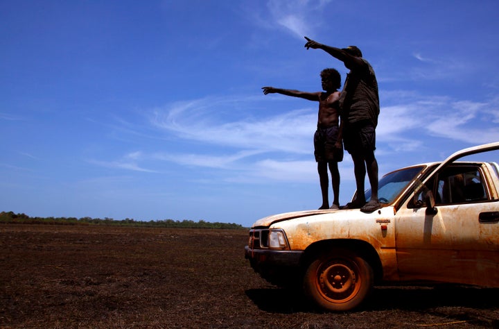Australian Aboriginal hunters Bruce and Robert Gaykamangu look for potential prey at a billabong near the outstation of Ngangalala in East Arnhem Land.