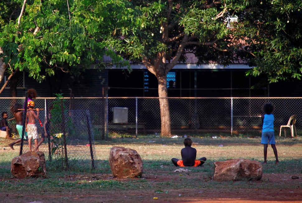 Members of the Australian Aboriginal community of Ramingining can be seen near their homes in East Arnhem Land, east of the Northern Territory city of Darwin.