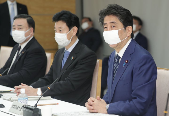 経済財政諮問会議でマスクを着用して発言する安倍晋三首相（右）。中央は西村康稔経済財政担当相＝3月31日、首相官邸