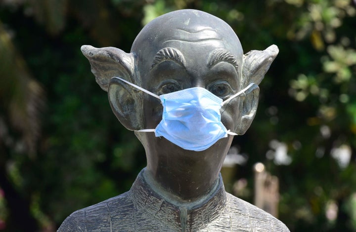 Protective mask put up on "Common Man" statue, following COVID 19 pandemic Worli Seaface, on March 30, 2020 in Mumbai.