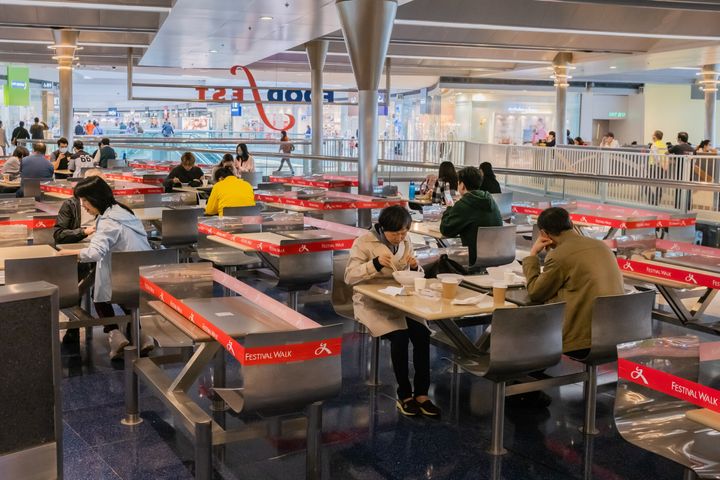 Customers sit in a canteen with taped off seatings to make sure people adhere to social distancing during a coronavirus (COVID-19) on March 29, 2020 in Hong Kong, China. 
