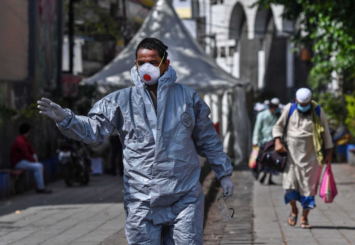  A government official in protective gear in New Delhi's Nizamuddin West on March 31, 2020 in New Delhi, India. 