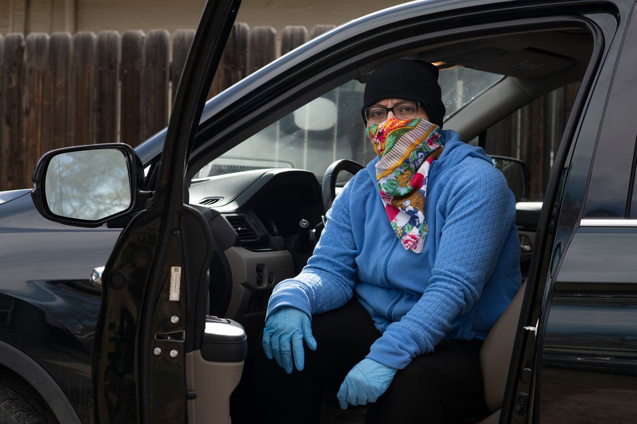 Dominguez poses in her deep cleaning outfit on March 30, 2020, at her house in Denver.