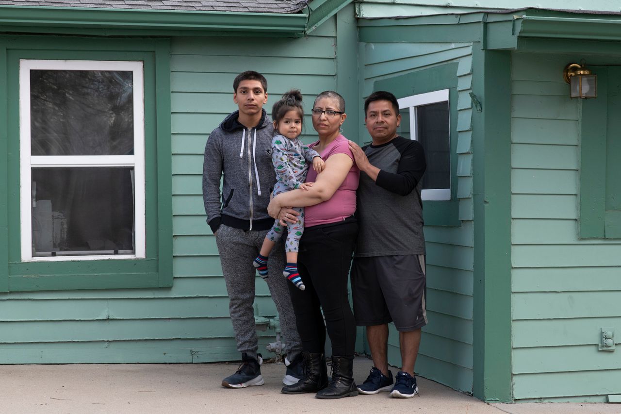 From left: Jorge Garcia, 15, stands with his mother, Ezzie Dominguez, who is holding her son Cristian Dominguez, 2, next to her husband, Jesus Dominguez, as they all pose on March 30, 2020, at their Denver home.