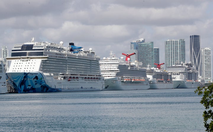 The U.S. Coast Guard said it has directed all cruise ships to treat any sick passengers and crew members on board “indefinitely” offshore during the coronavirus pandemic. Cruise ships are seen docked in Miami.