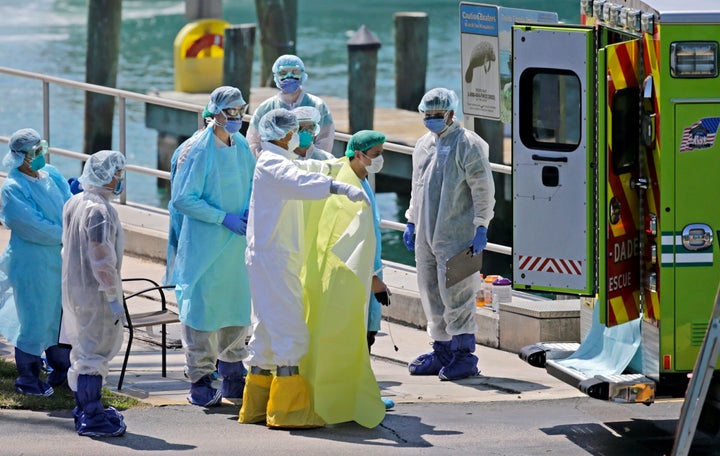 First responders care for crew members as they arrive by lifeboats from the cruise ship Costa Magica at the US Coast Guard Station Miami Beach on Thursday, March 26.