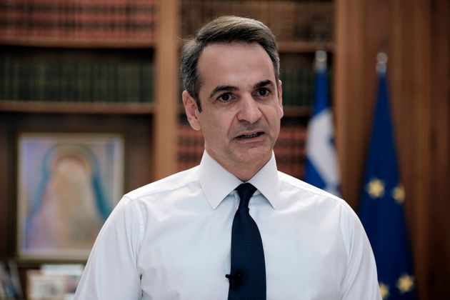 In this photo provided by the Greek Prime Minister's Office, Greece's Prime Minister Kyriakos Mitsotakis addresses the Greek nation on State TV in Athens, Sunday, March 22, 2020. Mitsotakis has announced a lockdown, starting at 6 a.m. (03.00 gmt) Monday. All citizens and residents must stay at home, or risk a 150-euro fine. The vast majority of people recover from the new coronavirus. According to the World  Health Organization, most people recover in about two to six weeks, depending on the severity of the illness. (Dimitris Papamitsos/Greek Prime Minister's Office via AP)