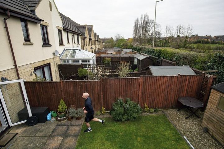James Campbell runs a charity marathon to raise funds for the NHS, in his garden, while the country is in lockdown to control the spread of coronavirus, in Cheltenham, England.