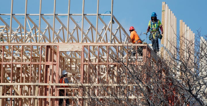 Construction workers continue to toil at a Denver site Thursday as a statewide stay-at-home order takes effect in Colorado to reduce the spread of the coronavirus.