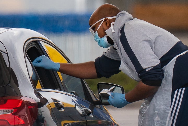 Medical staff at an NHS drive through coronavirus disease (COVID-19) testing facility in an IKEA car park, Wembley